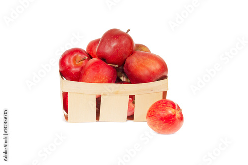 Fresh red apples in wooden basket isolated, autumn harvest