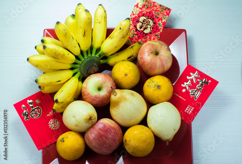 various fruits in chinese new year, orange, watermelon, apples, pears and bananas photo