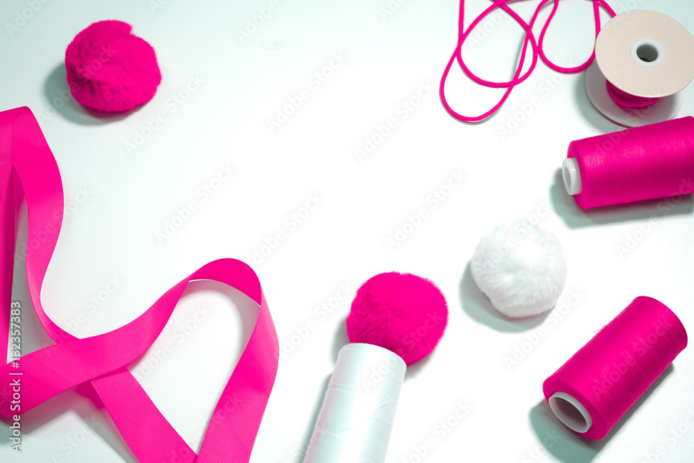 Accessories for sewing lie on a white background. Measuring tape, thread, fabric and needles . Accessories for sewing lie on a white background. Measuring tape, thread, fabric and needles .