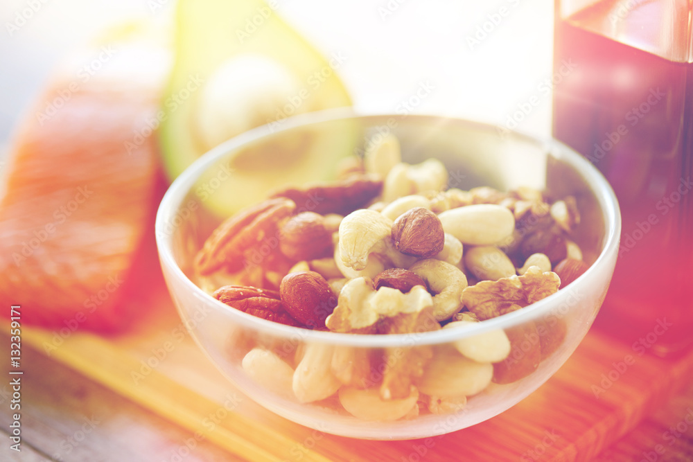 close up of nut mix in glass bowl on table close up of nut mix in glass bowl on table