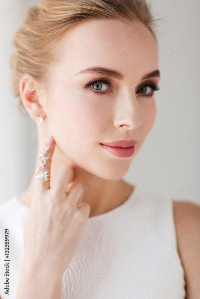 smiling woman in white dress with diamond jewelry smiling woman in white dress with diamond jewelry