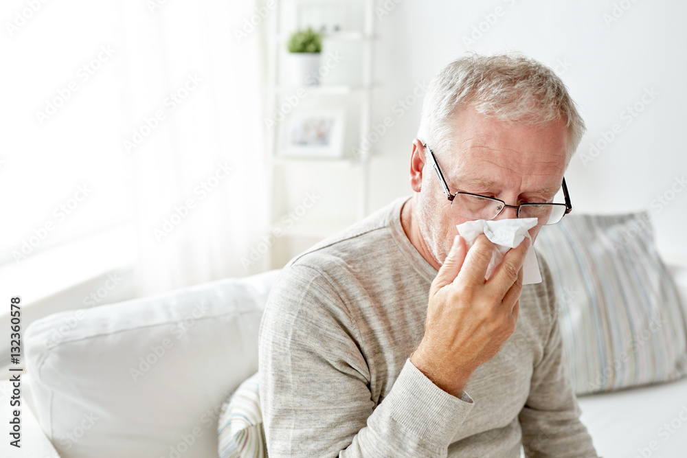 sick senior man with paper wipe blowing his nose sick senior man with paper wipe blowing his nose