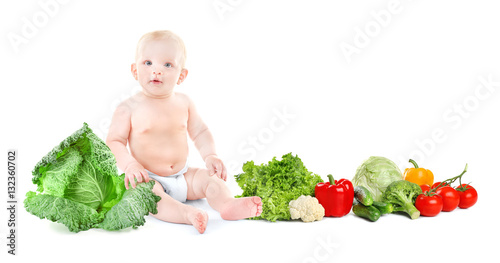 Cute baby with vegetables o...