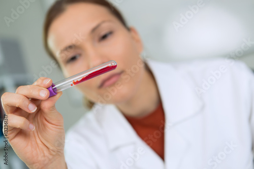 female lab worker holding test-tube