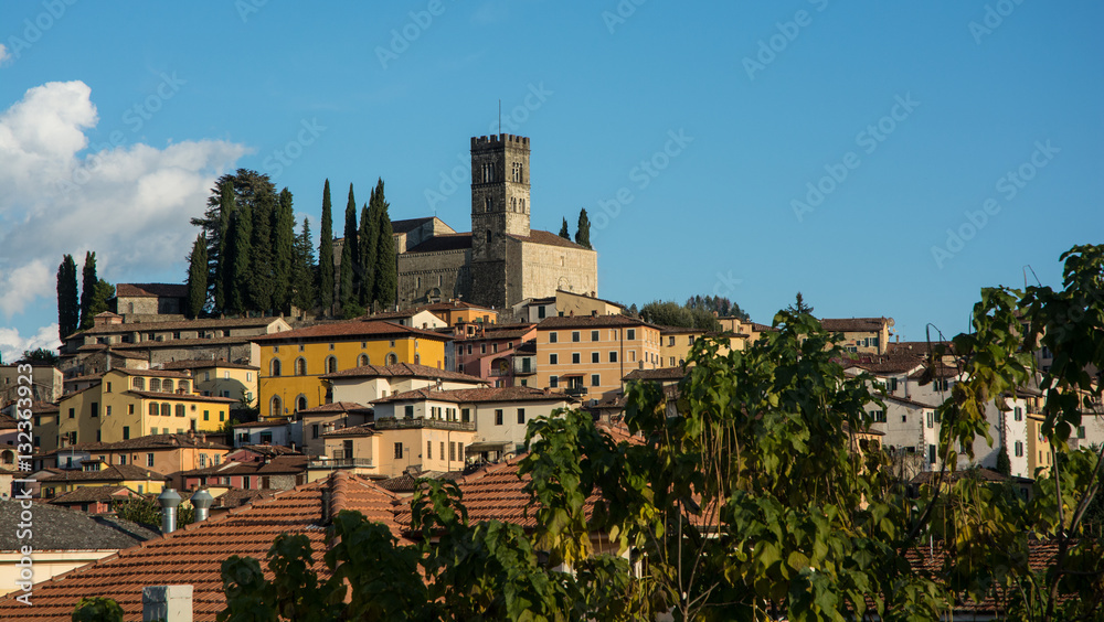 A stone church overlooks the town of Barga in Italy