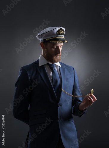 Portrait of a handsome sailor on a dark background photo