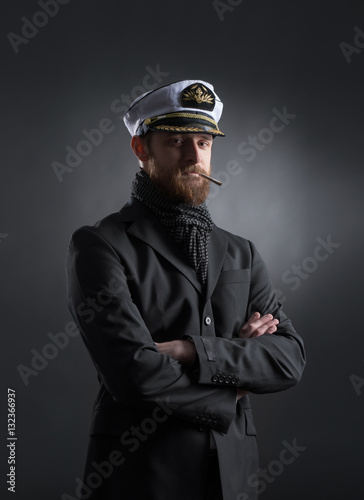 Portrait of a handsome sailor on a dark background photo