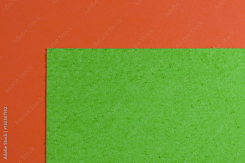 Eva foam ethylene vinyl acetate sponge plush apple green surface on orange smooth background Eva foam ethylene vinyl acetate sponge plush apple green surface on orange smooth background