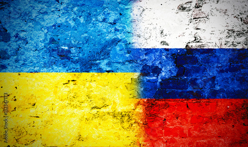 Governments conflict concept. Damaged wall colored in Ukrainian and Russian flags