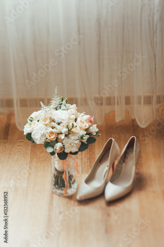 bridal bouquet of white flowers. bride's shoes
