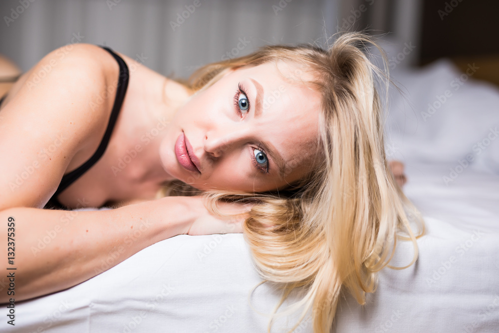 Face portrait of blonde sexy girl in her bed in black lingerie Face portrait of blonde sexy girl in her bed in black lingerie