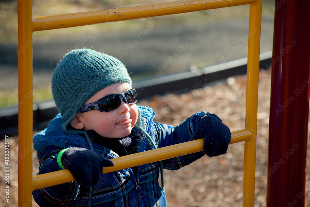 Obraz premium adorable toddler boy climbing ladder on playground