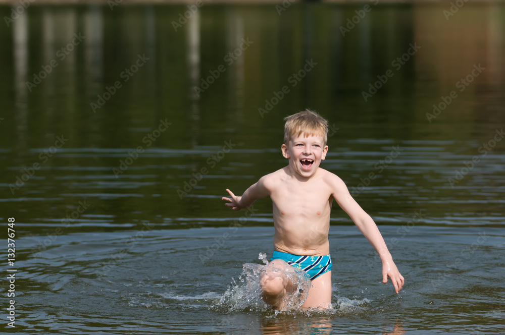 Six years old boy going out the lake Six years old boy going out the lake