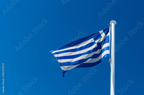 State flag of Greece against the blue sky.