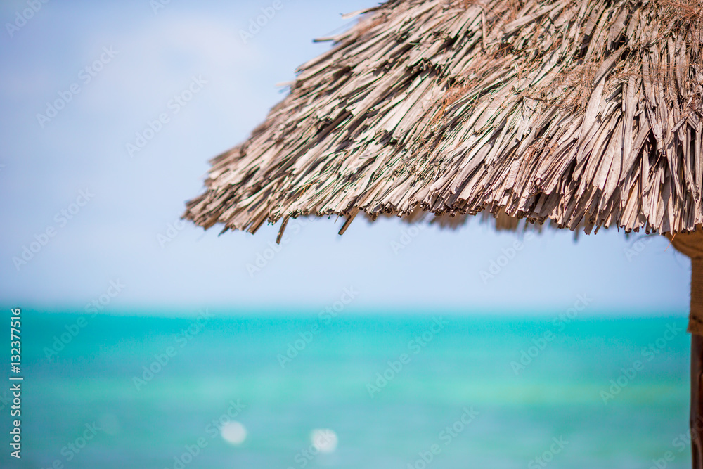 Closeup straw beach umbrella on tropics Closeup straw beach umbrella on tropics