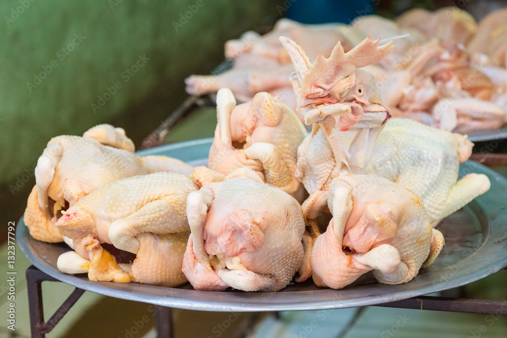 Plucked chicken with head offered on a market in Hanoi, Vietnam