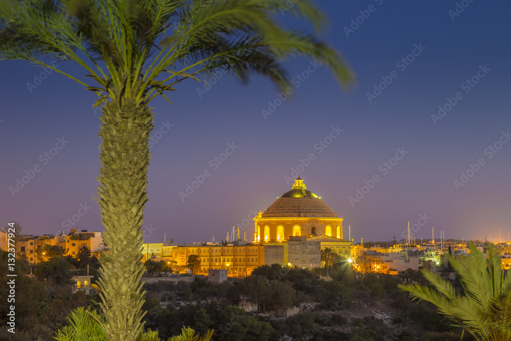 Mosta, Malta - The Mosta Dome or The Church of the Assumption of Our Lady, commonly known as the Rotunda of Mosta with palm tree by night