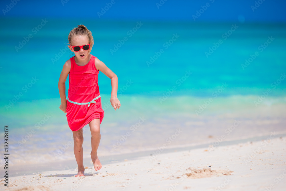 Cute little girl at beach during tropical vacation Cute little girl at beach during tropical vacation