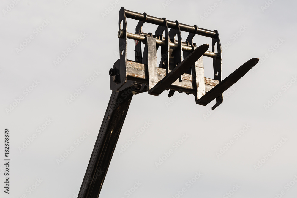 Bucket lift with blue sky in background Bucket lift with blue sky in background