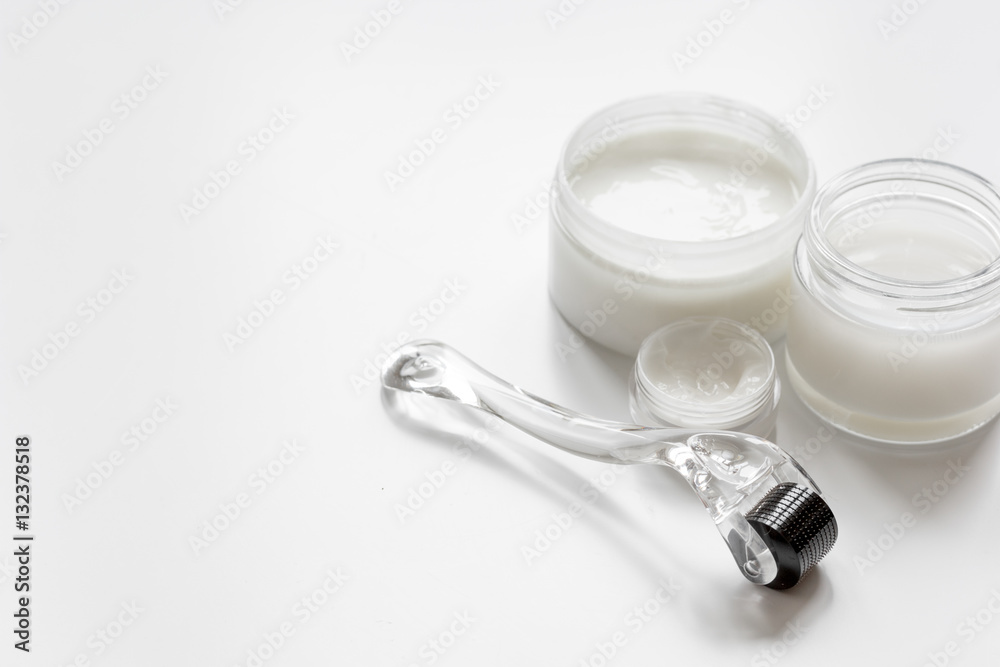 concept beautician desktop with mezoroller - mesotherapy on white background concept beautician desktop with mezoroller - mesotherapy on white background