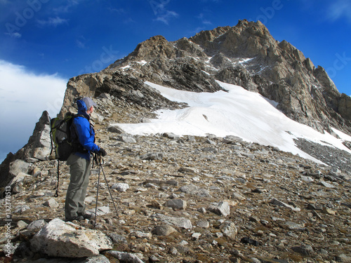Man Hiking in Rugged Mountains Climbing Peaks