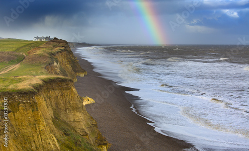 Rainbow off Weybourne Norfolk in rain storm photo