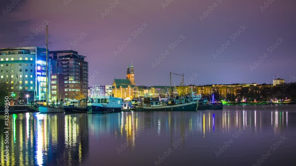 Time Lapse of small harbor at night. Stockholm cityscape in the background Time Lapse of small harbor at night. Stockholm cityscape in the background