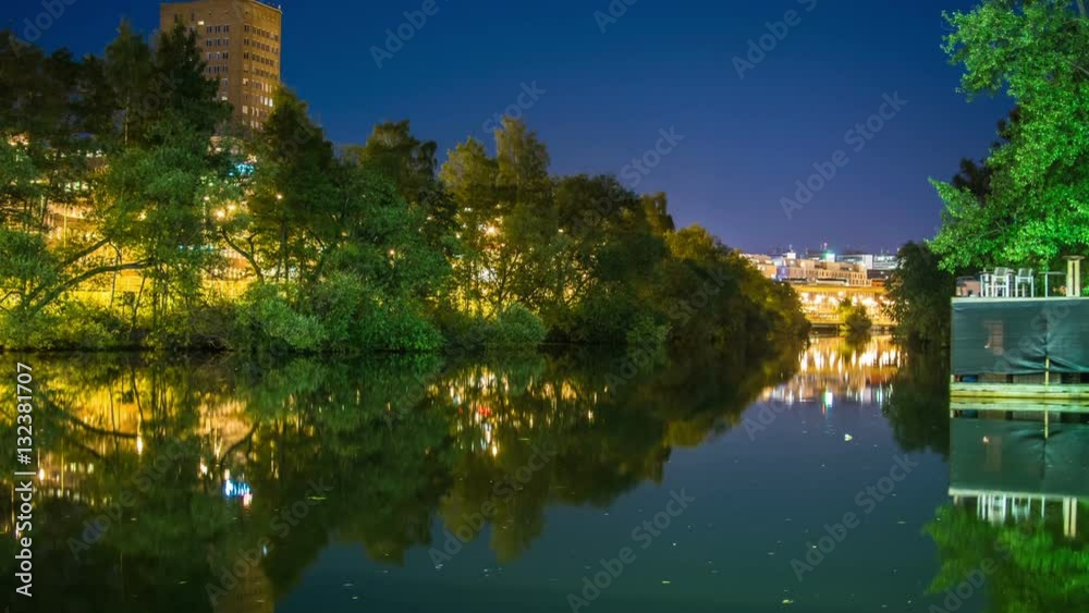 Time Lapse of city riverside canal at night. Mirror reflection in the water Time Lapse of city riverside canal at night. Mirror reflection in the water