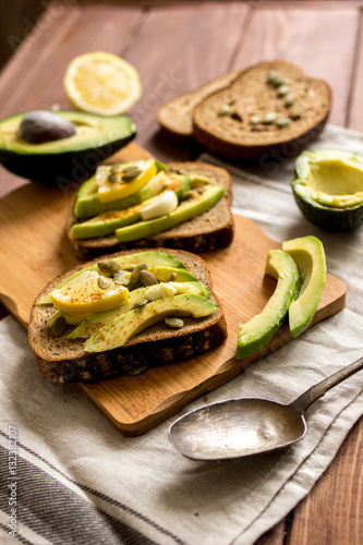 making sandwiches with avocado healthy organic food top view