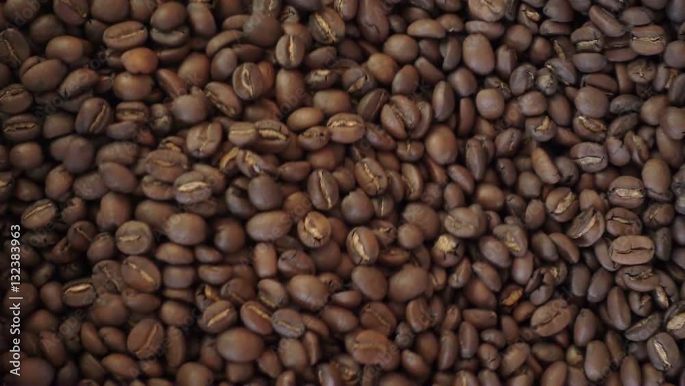 Mixing roasted coffee in slow motion close-up Mixing roasted coffee in slow motion close-up