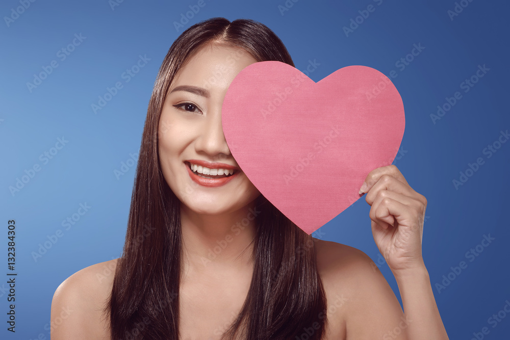 Young asian woman holding red heart shape Young asian woman holding red heart shape