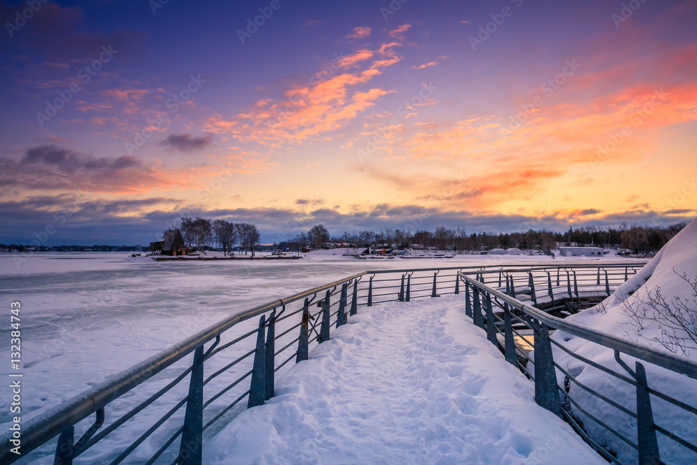 Naklejka premium View of a frozen lake during sunrise in winter season. Location: Ramsey Lake, Ontario, Canada