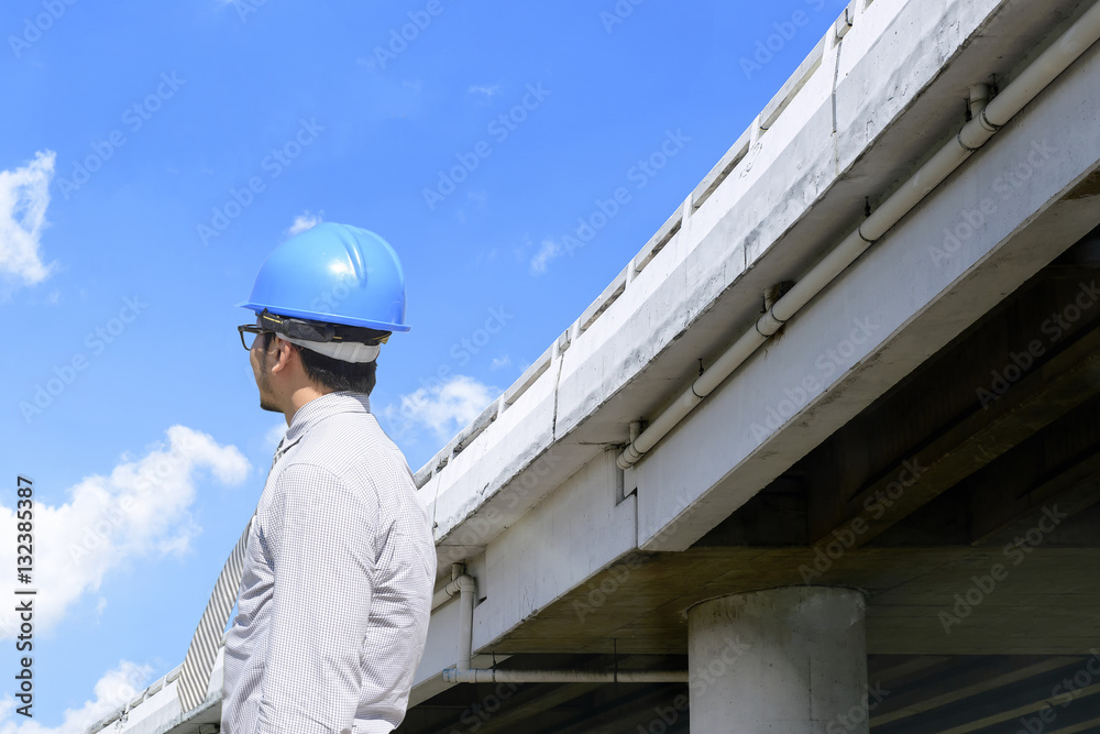 The engineer man looking along the express way construction with the blue sky The engineer man looking along the express way construction with the blue sky