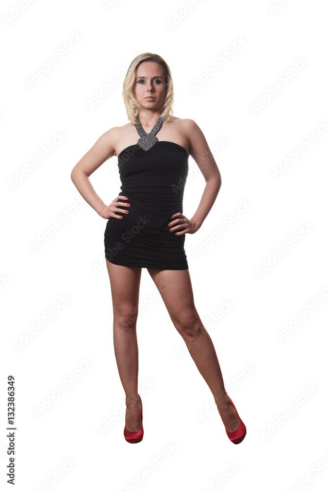 Fototapeta premium woman in a short black dress and red heels posing isolated on white background