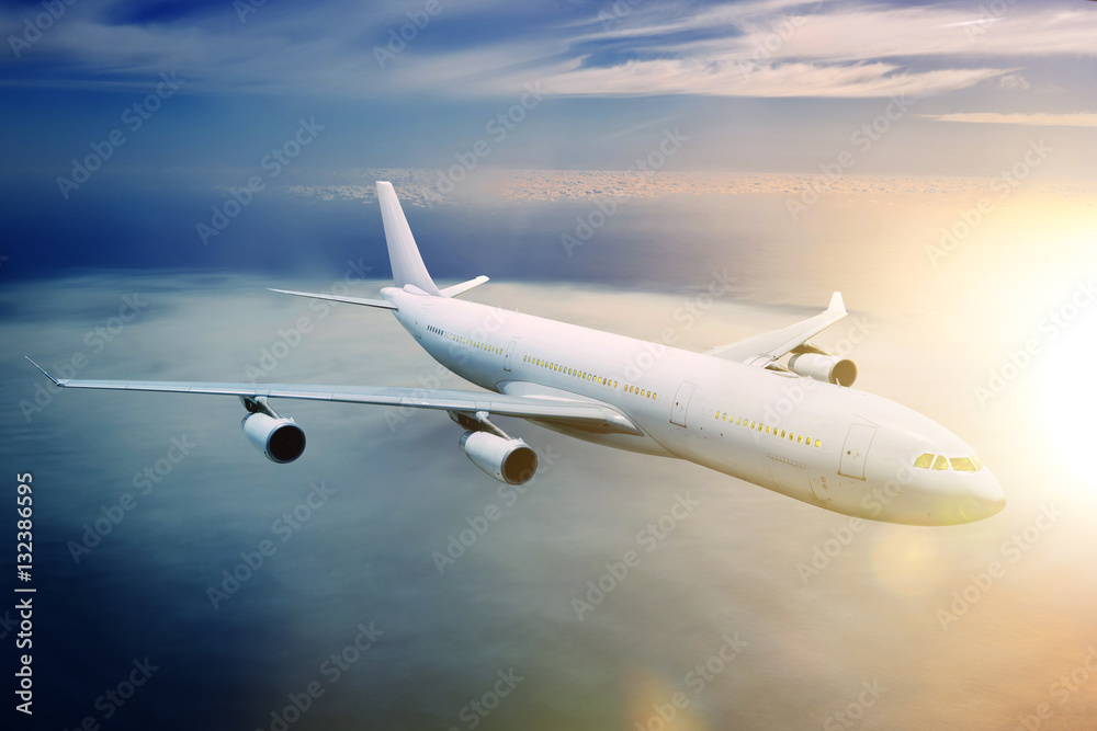 Fototapeta premium Airplane in the sky at sunset