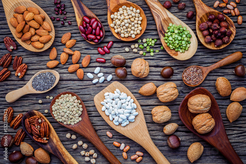 Various legumes and different kinds of nutshells in spoons. Waln