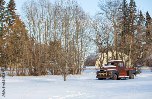 Rusted vintage 1950s truck in a white winter landscape