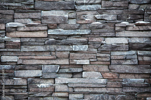 Grey and brown exterior brick wall abstract background