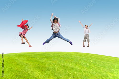 Happy children jumping outdoors