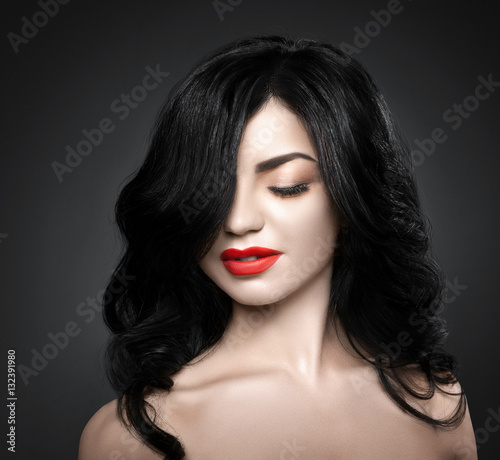 Beautiful brunette woman with shot hairstyle and sexy red lips.