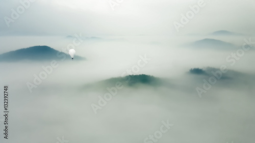 Fly over the clouds with a hot air balloon
