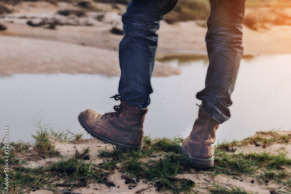 Tourists hiking shoes Standing on the edge of a cliff along the Tourists hiking shoes Standing on the edge of a cliff along the