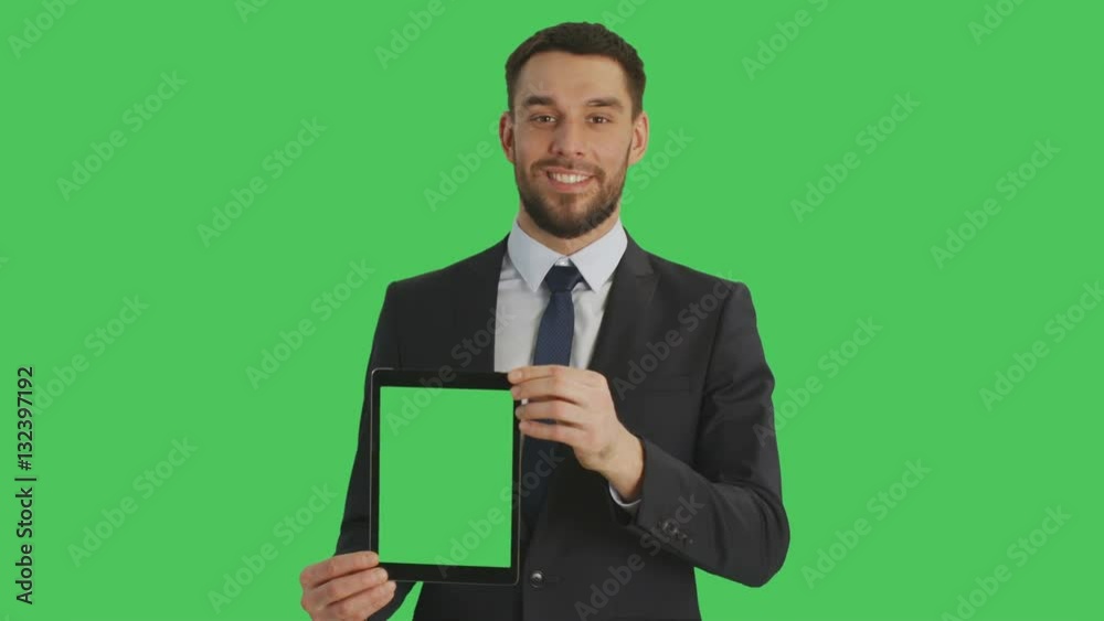 Mid Shot of a Smiling Handsome Businessman Holding Vertically Tablet Computer with Green Screen. Green Screen in Background. Shot on RED Cinema Camera 4K (UHD). Mid Shot of a Smiling Handsome Businessman Holding Vertically Tablet Computer with Green Screen. Green Screen in Background. Shot on RED Cinema Camera 4K (UHD).