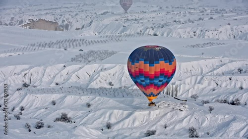 Hot air balloon landing in Cappadocia during winter