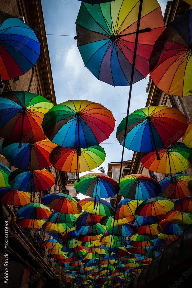 Color picture of colorful umbrella roof between buildings
