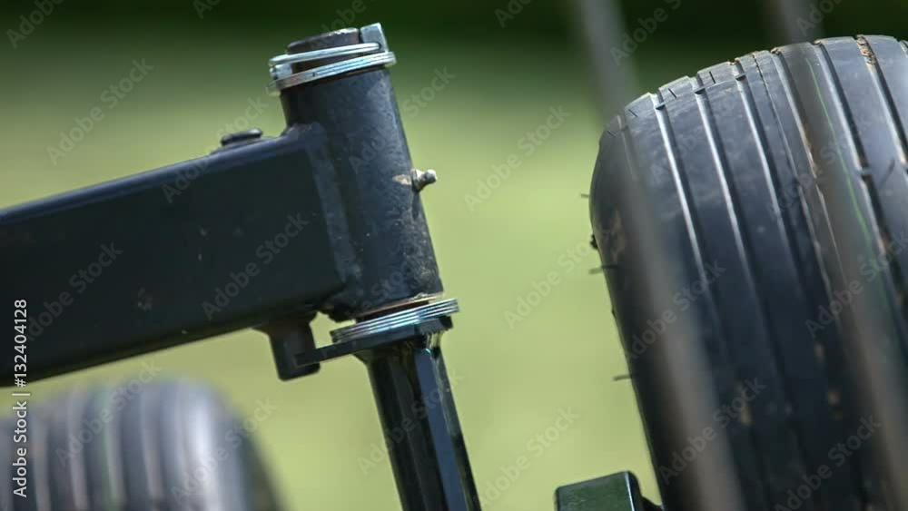 We can see agricultural machinery and two wheels. This is one part of the rotary hay rakes.
We can see agricultural machinery and two wheels. This is one part of the rotary hay rakes.
