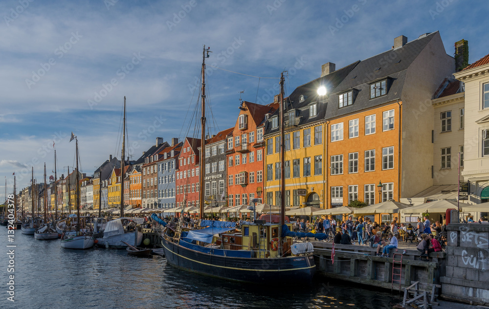 Nyhavn, Copenhagen, Denmark - September 2016. Crowds of locals and tourists enjoy the warm and beautiful weather in one of the most beautiful spots of the danish capital