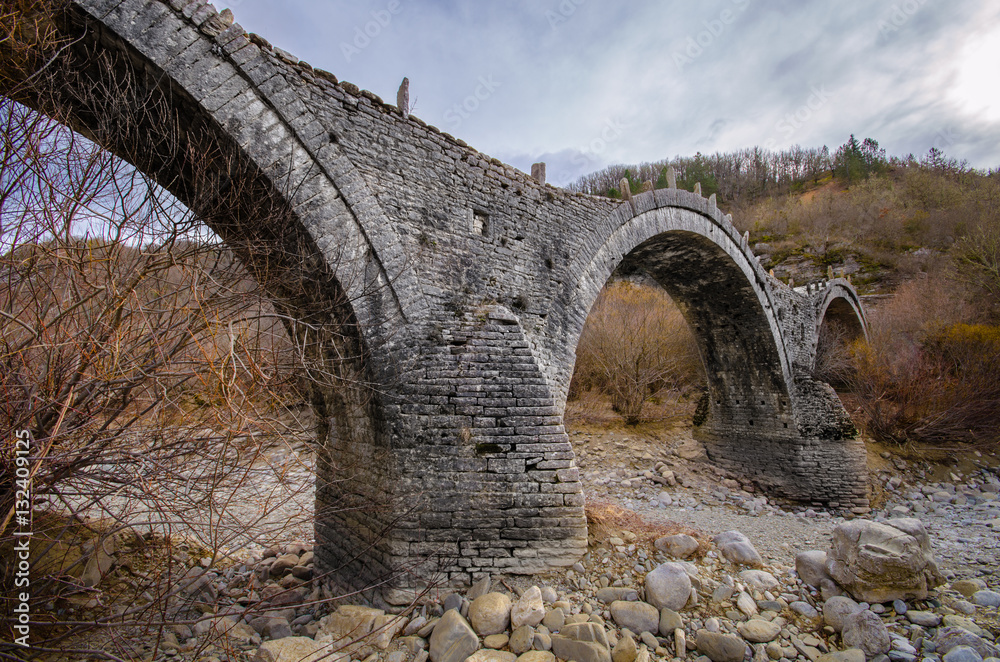 Old Plakida - Kalogeriko arched stone bridge on Vikos canyon, Zagorohoria, Greece. 