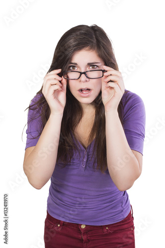Foto Brunette woman in glasses peering in amazement isolated on white