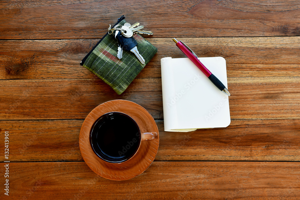 Notebook with Blank Pages, Pen and Cup of Coffee on Wooden Table. Top View Notebook with Blank Pages, Pen and Cup of Coffee on Wooden Table. Top View